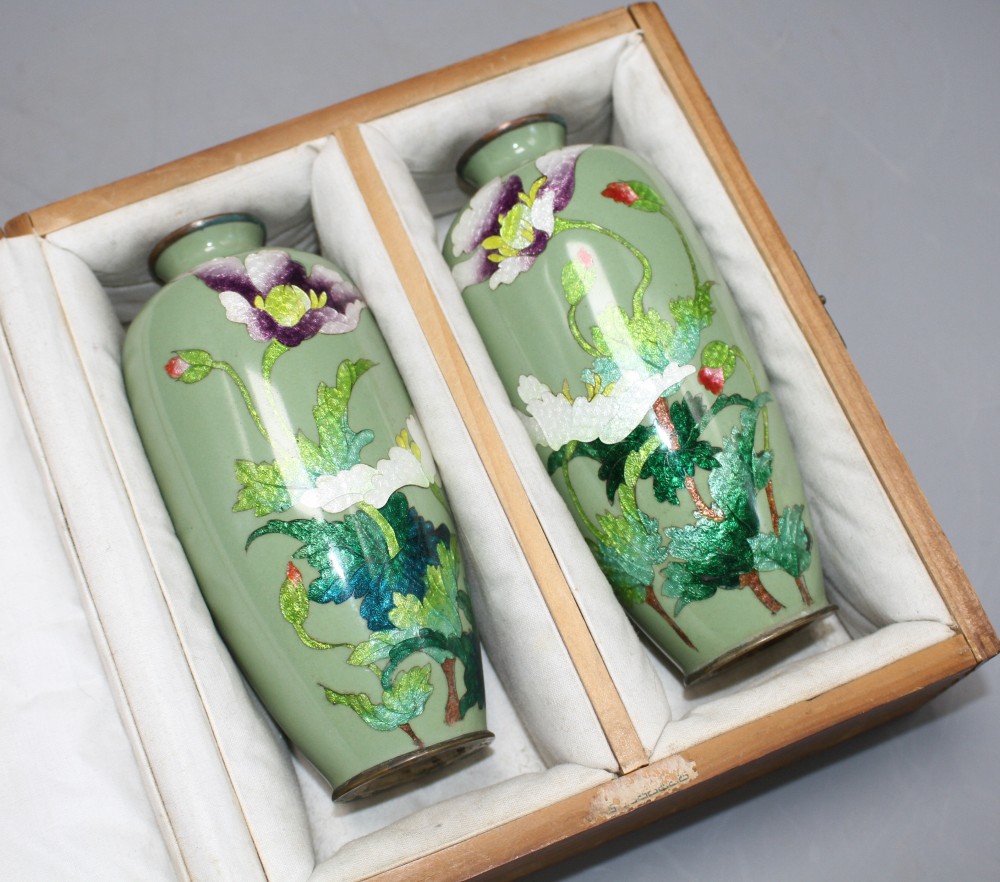 A pair of Japanese late Meiji period cloisonne vases, decorated with flowers on a celadon green ground, height 15cm, with original box